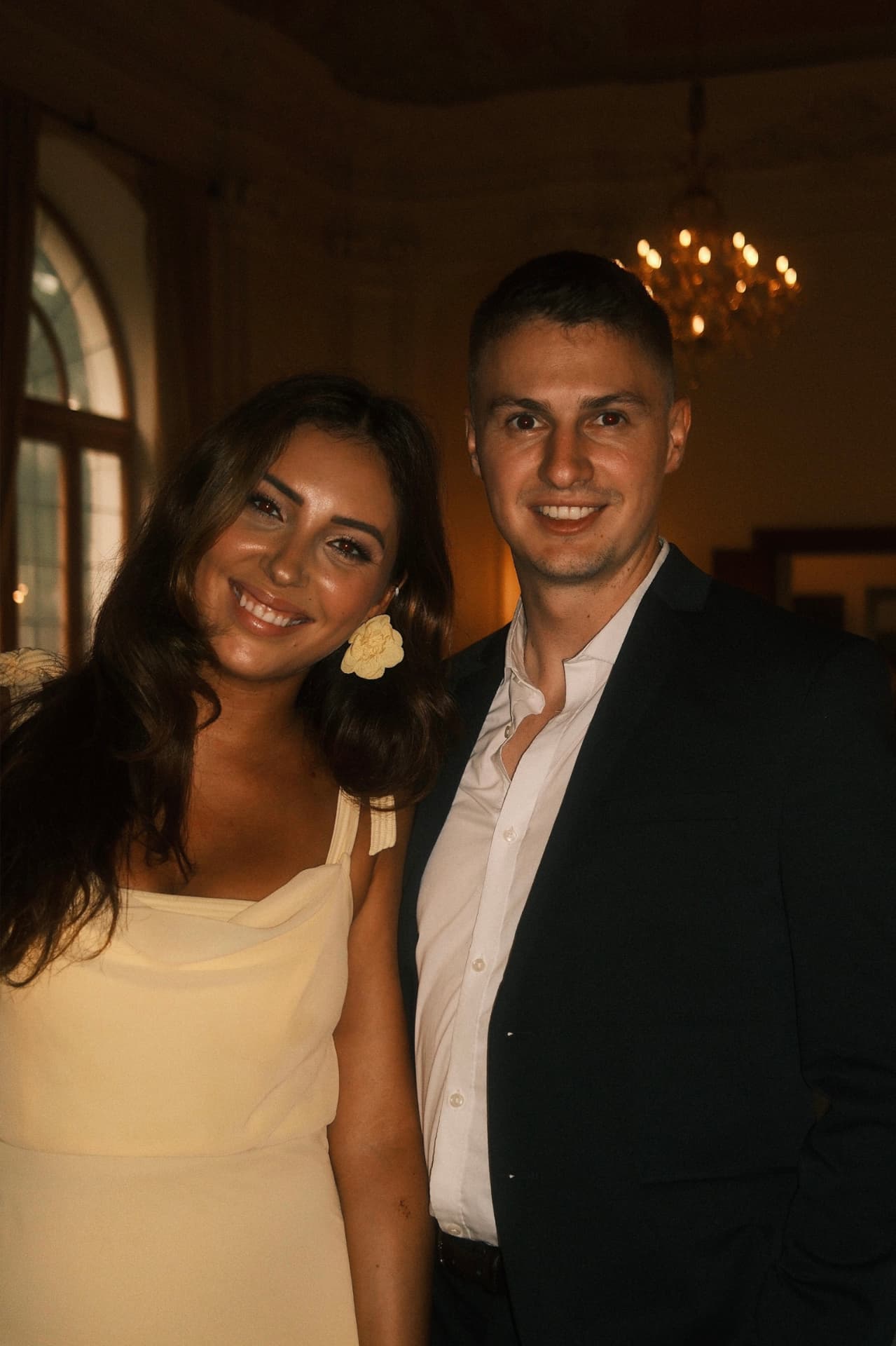 Jasmin and Filip laughing together with a glass of champagne